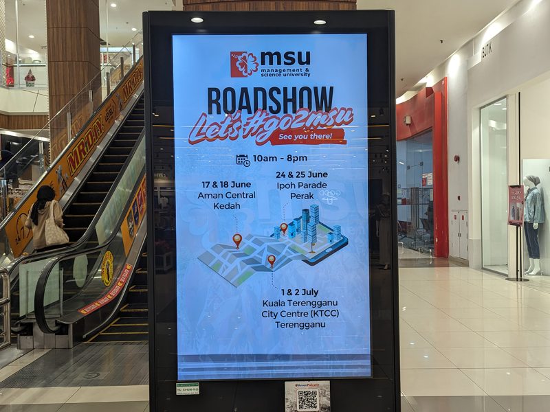Kesion Malaysia digital standing screen displaying an MSU roadshow schedule in AEON shopping mall.