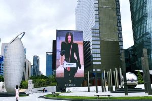 Massive freestanding vertical digital billboard displaying a Burberry fashion campaign at the Parnas Plaza in Gangnam, Seoul.