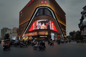 Massive corner digital billboard displaying a Bia Saigon advertisement on the Vincom Center Phạm Ngọc Thạch in Hanoi, Vietnam