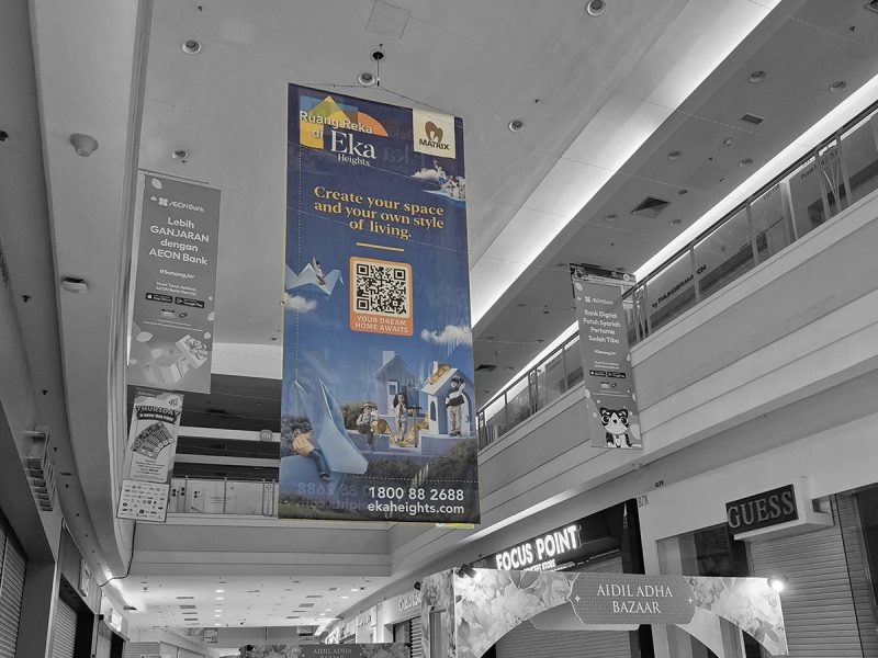 Tall vertical banner hanging in a shopping mall promoting Eka Heights by Matrix, with the tagline "Create your space and your own style of living"